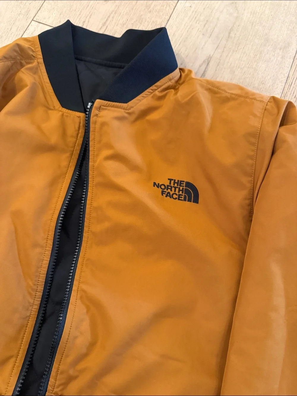 The North Face Men's Quilted Bomber Jacket in Black with Mustard reversible